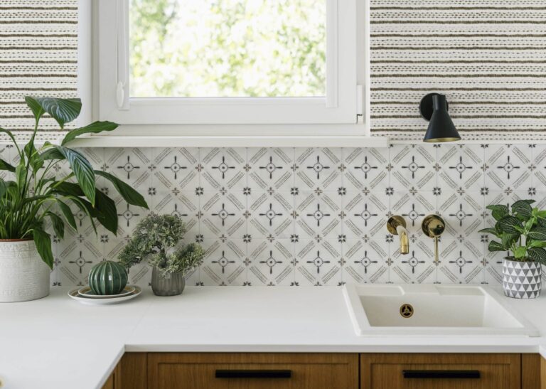 Modern kitchen interior with white sink and potted plants on counter Mila