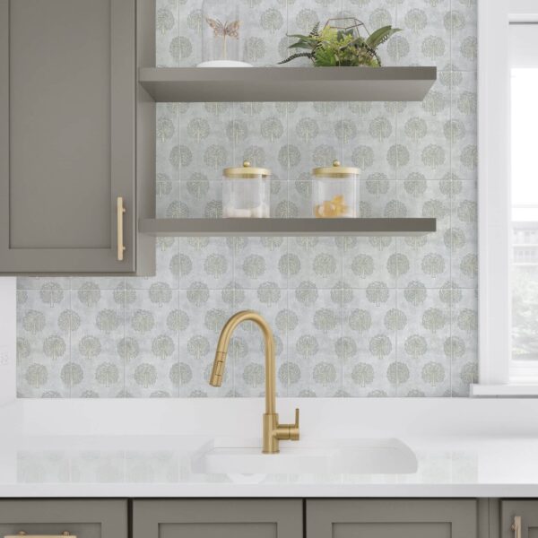A gold faucet detail with grey cabinets Eda